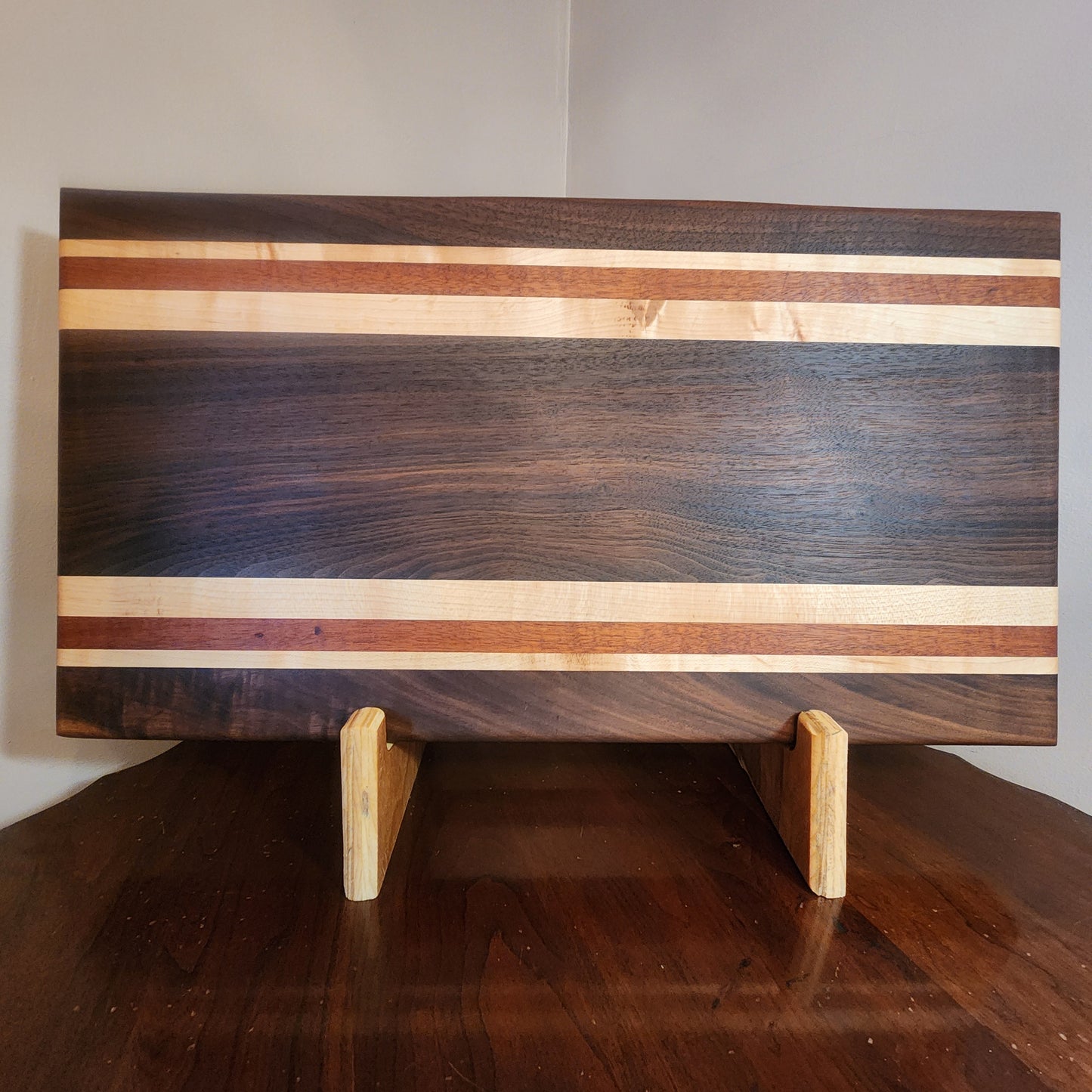 Walnut,maple,mahogany with walnut center. Food safe oil wax finish. 21.25"x11.25"x1.75"display stand sold separately