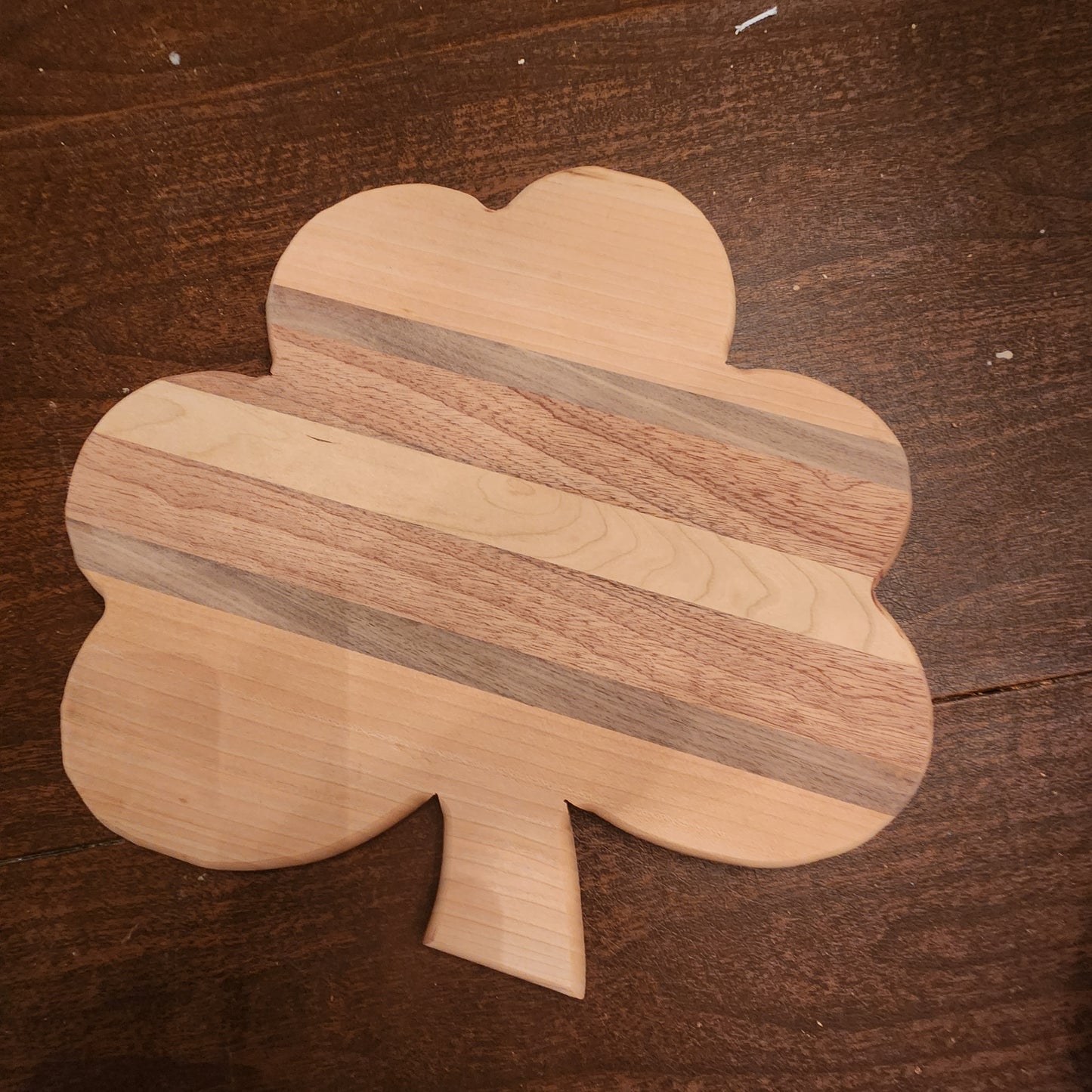 Shamrock shaped cutting boards/serving trays color and wood variation. Solid maple, maple/mahogany, mahogany, maple,walnut